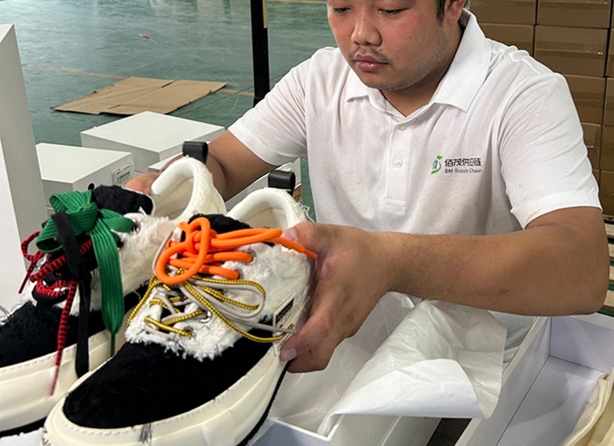 warehouse staff inspecting and packing footwear products during pick and pack fulfillment process for ecommerce orders