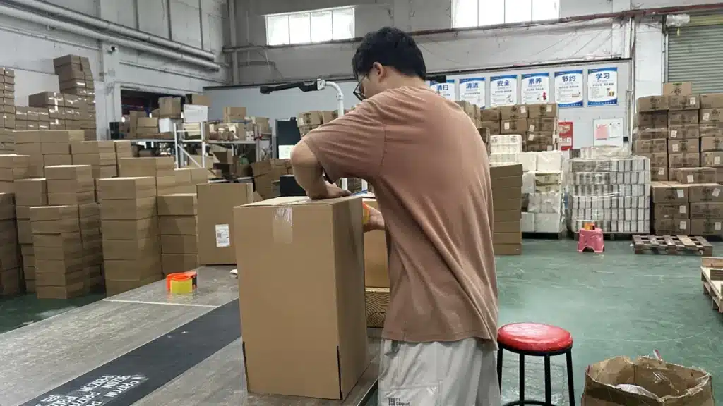 Warehouse worker sealing a prepared ecommerce order after product verification as part of a controlled 3PL fulfillment process for improving order accuracy rate.