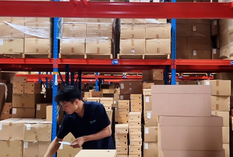 warehouse worker in guangzhou packing ecommerce orders in fulfillment center