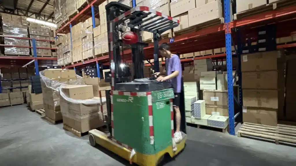 Warehouse worker operating a forklift among stocked fulfillment racks, illustrating diversified fulfillment operations and multi-location supply chain resilience.