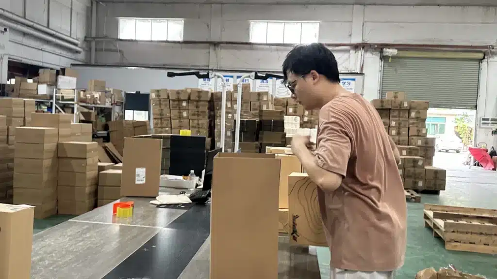 Warehouse worker packing an eCommerce order as part of a professional China fulfillment process designed to improve shipping reliability.