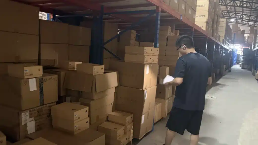 Warehouse worker picking eCommerce inventory in a China 3PL warehouse as part of an integrated order fulfillment and shipping process.