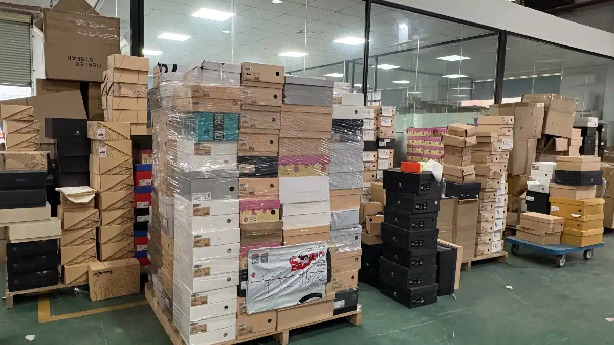 Warehouse worker checking stored products to maintain accurate inventory data for AI inventory forecasting and ecommerce demand planning.