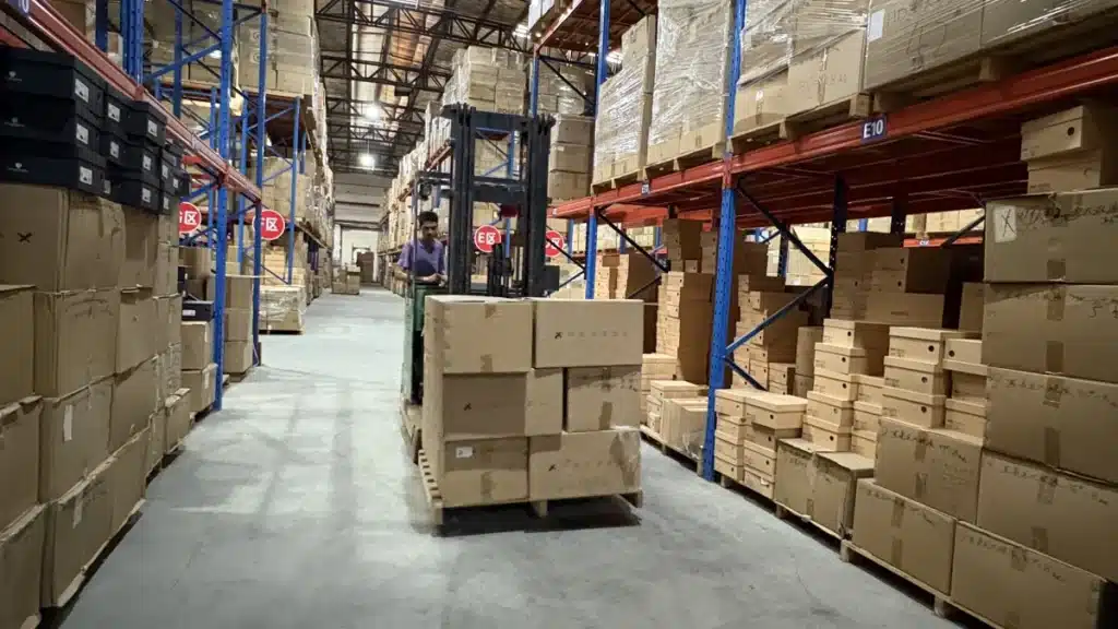 Warehouse worker moving palletized inventory through a 3PL warehouse as part of storage, inventory management, and fulfillment operations.