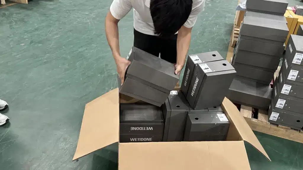 Warehouse employee packing product boxes for shipment, showing how third-party pick and pack services support scalable eCommerce order fulfillment.