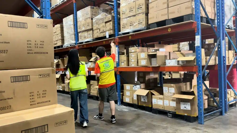 Warehouse staff checking organized inventory as part of China warehousing services for international eCommerce sellers