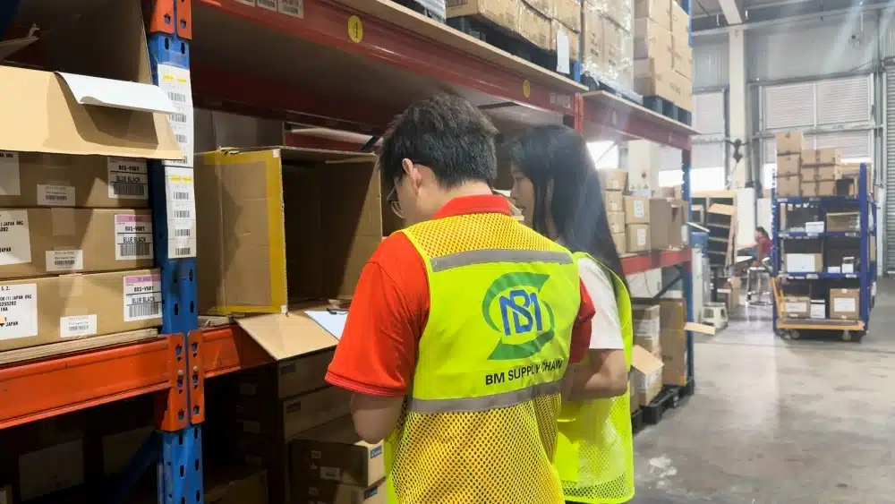 Warehouse staff checking stored inventory in a China warehouse for supplier coordination, quality control, and international eCommerce fulfillment
