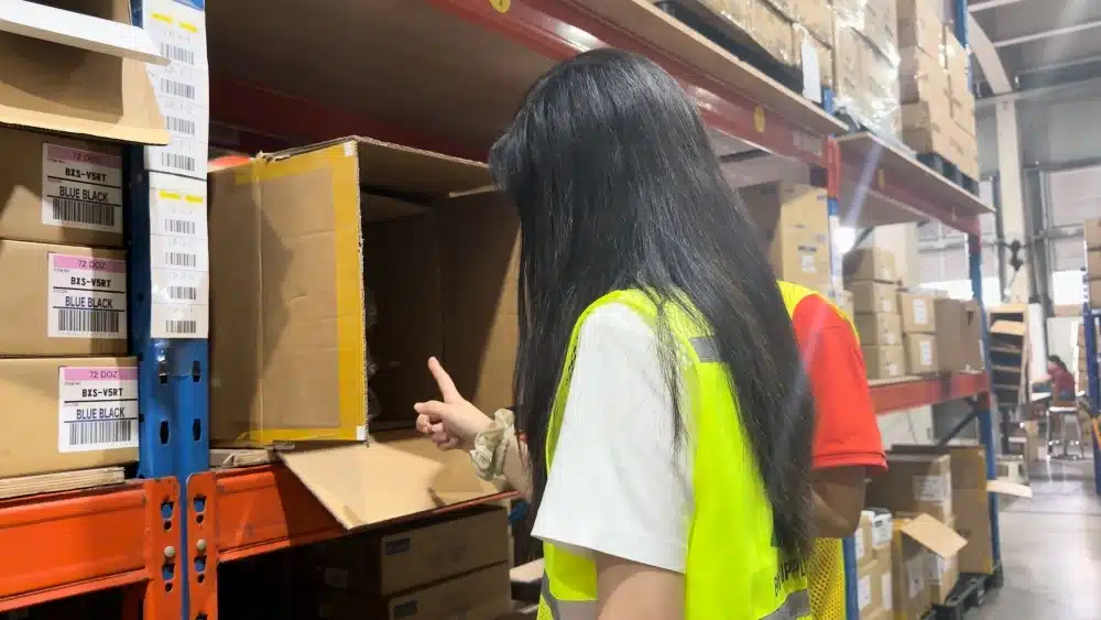 Warehouse staff checking inventory locations in a fulfillment center to support accurate picking, inventory management, and eCommerce order fulfillment