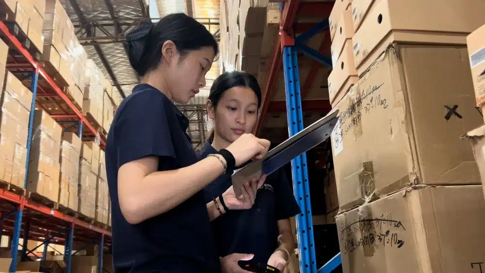 Warehouse staff checking inventory and order data to manage fulfillment costs for a profitable eCommerce free shipping strategy