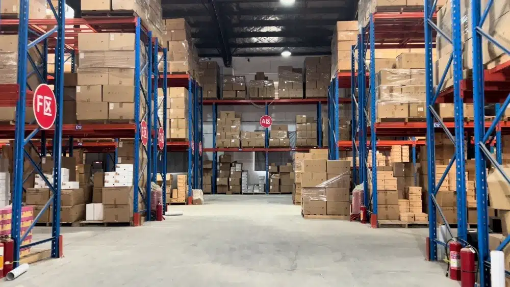 Warehouse storage racks filled with eCommerce inventory showing how pick and pack fulfillment differs from inventory-free dropshipping