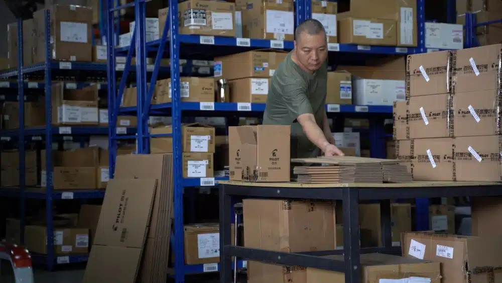 Warehouse worker preparing cartons for pick and pack services as part of an eCommerce order fulfillment operation