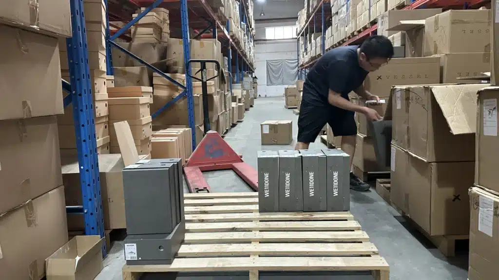 Warehouse worker preparing products for fulfillment in a China warehouse, showing operational efficiency, inventory handling, and order processing capability.