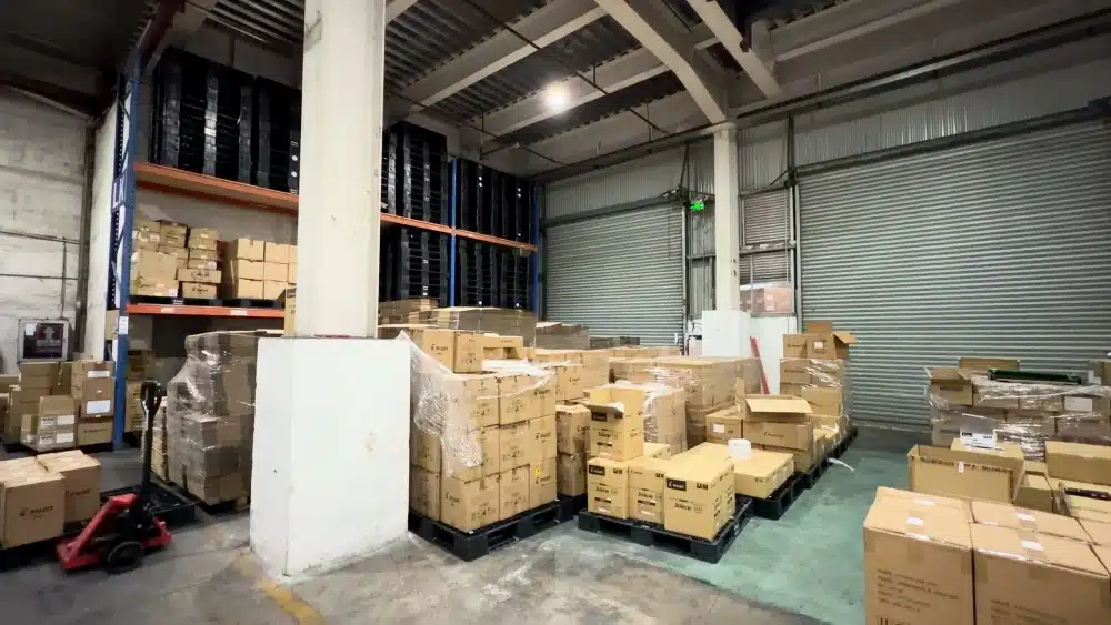 Warehouse workers handling packaged goods for ecommerce fulfillment and carbon neutral shipping strategies focused on sustainable logistics operations