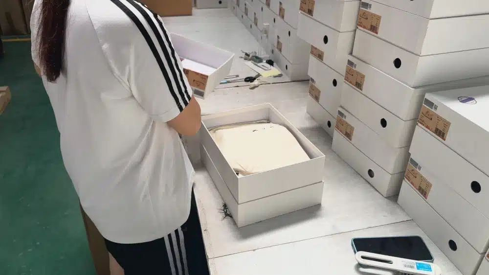 Warehouse staff organizing product inventory in storage racks for ecommerce order processing and logistics management