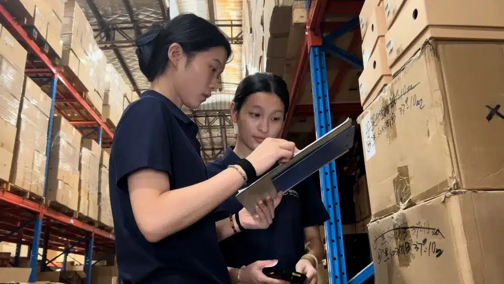Warehouse employees inspecting inventory and packages to improve fulfillment accuracy, operational efficiency, and ecommerce carbon footprint management