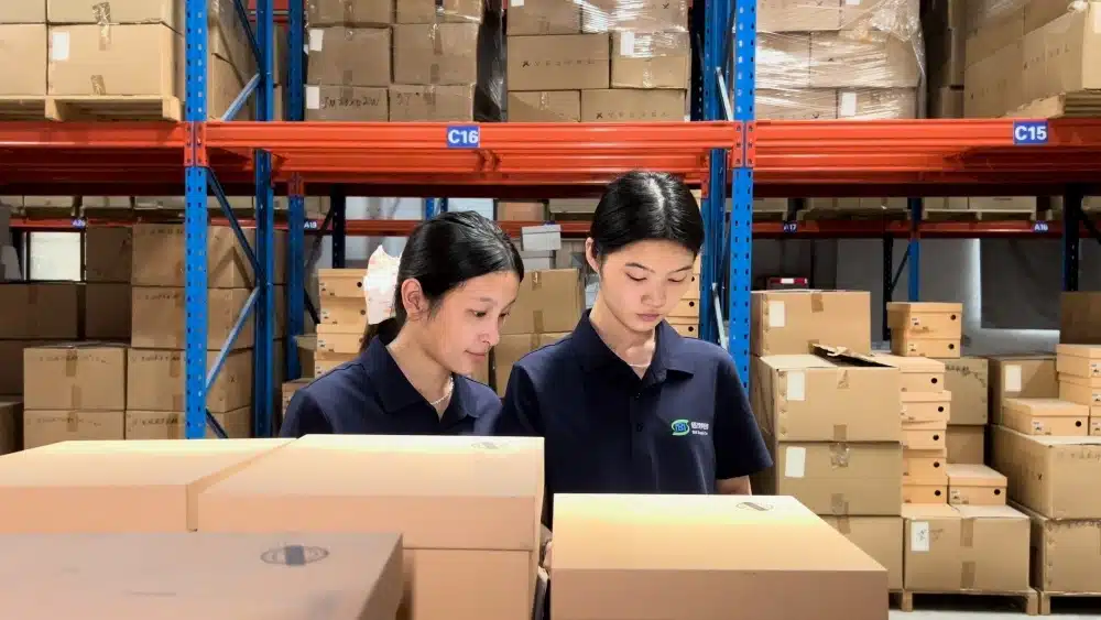 Warehouse employees inspecting ecommerce packages to support reusable packaging systems, quality control, and sustainable return logistics