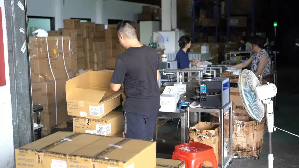 Warehouse workers preparing cardboard packages for sustainable ecommerce packaging solutions and eco-friendly fulfillment processes