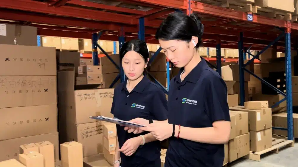 Fulfillment staff inspecting cardboard packages to ensure quality control for recyclable packaging and environmentally friendly ecommerce shipping