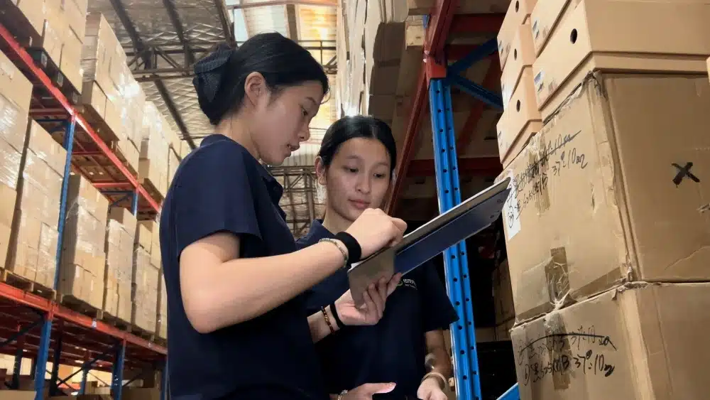 Fulfillment staff checking warehouse inventory and packaging conditions for sustainable ecommerce packaging quality control