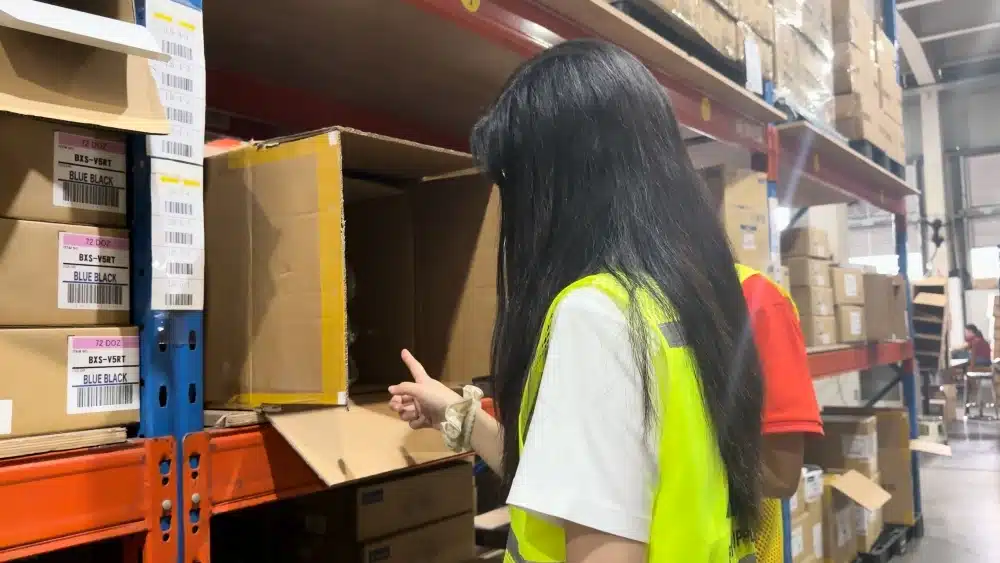 Warehouse staff checking labeled inventory in a China fulfillment center to prevent TikTok Shop stockouts and slow fulfillment penalties
