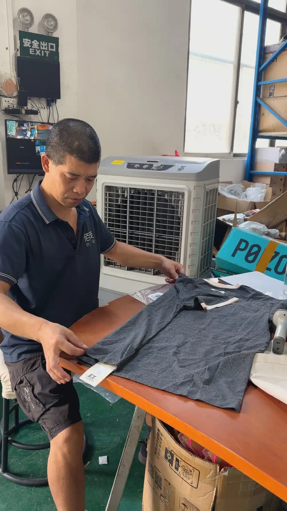 Warehouse worker performing apparel quality inspection for TikTok Shop fulfillment before products are packed and shipped to customers