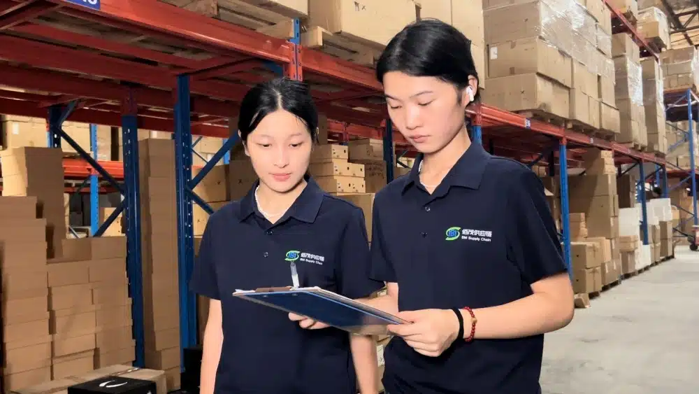 Warehouse staff reviewing ecommerce inventory for TikTok Shop and Amazon fulfillment operations in a China 3PL warehouse