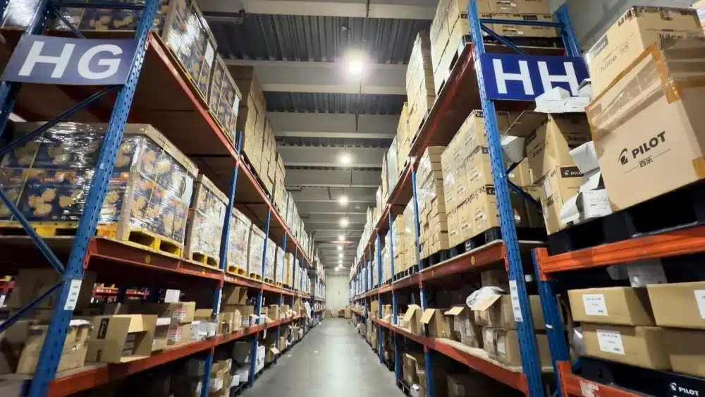 Large ecommerce fulfillment warehouse with organized inventory storage racks supporting carbon footprint tracking and sustainable supply chain optimization