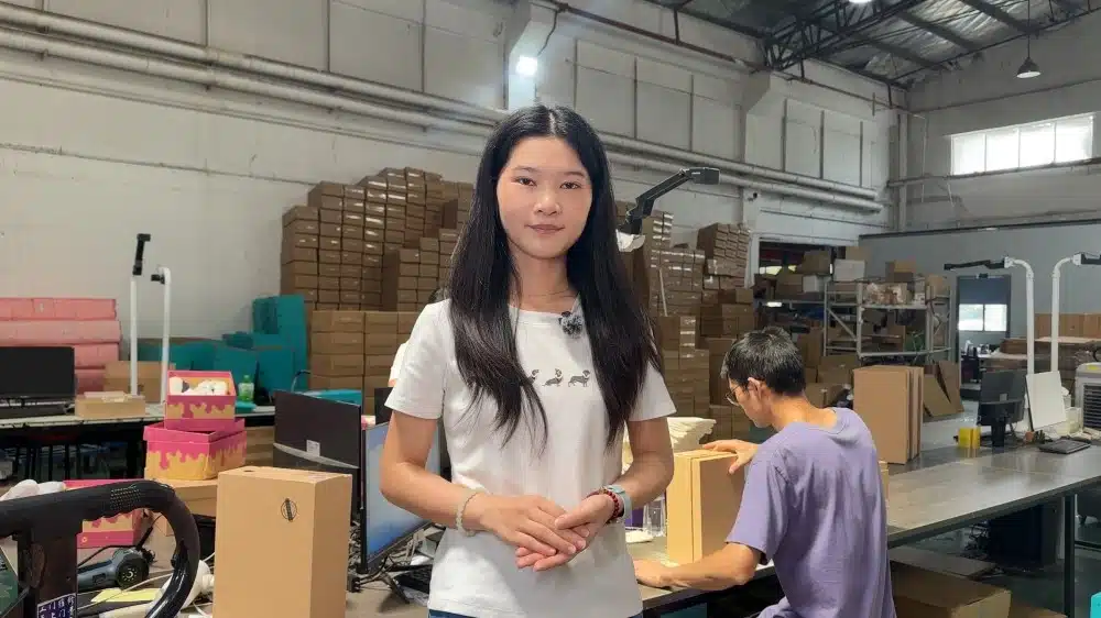 Warehouse staff managing logistics operations in a fulfillment center with inventory storage and packing workstations