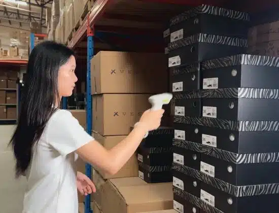 warehouse staff scanning product inventory with barcode system for China 3PL dropshipping fulfillment