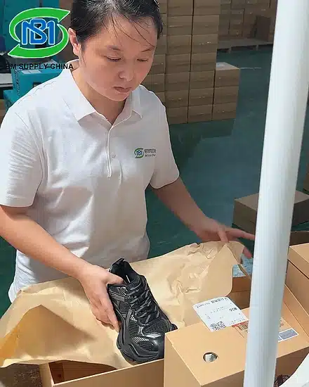 Shoe Fulfillment Packaging and Kitting Services warehouse worker packing shoes with protective packaging for custom footwear fulfillment and eCommerce orders